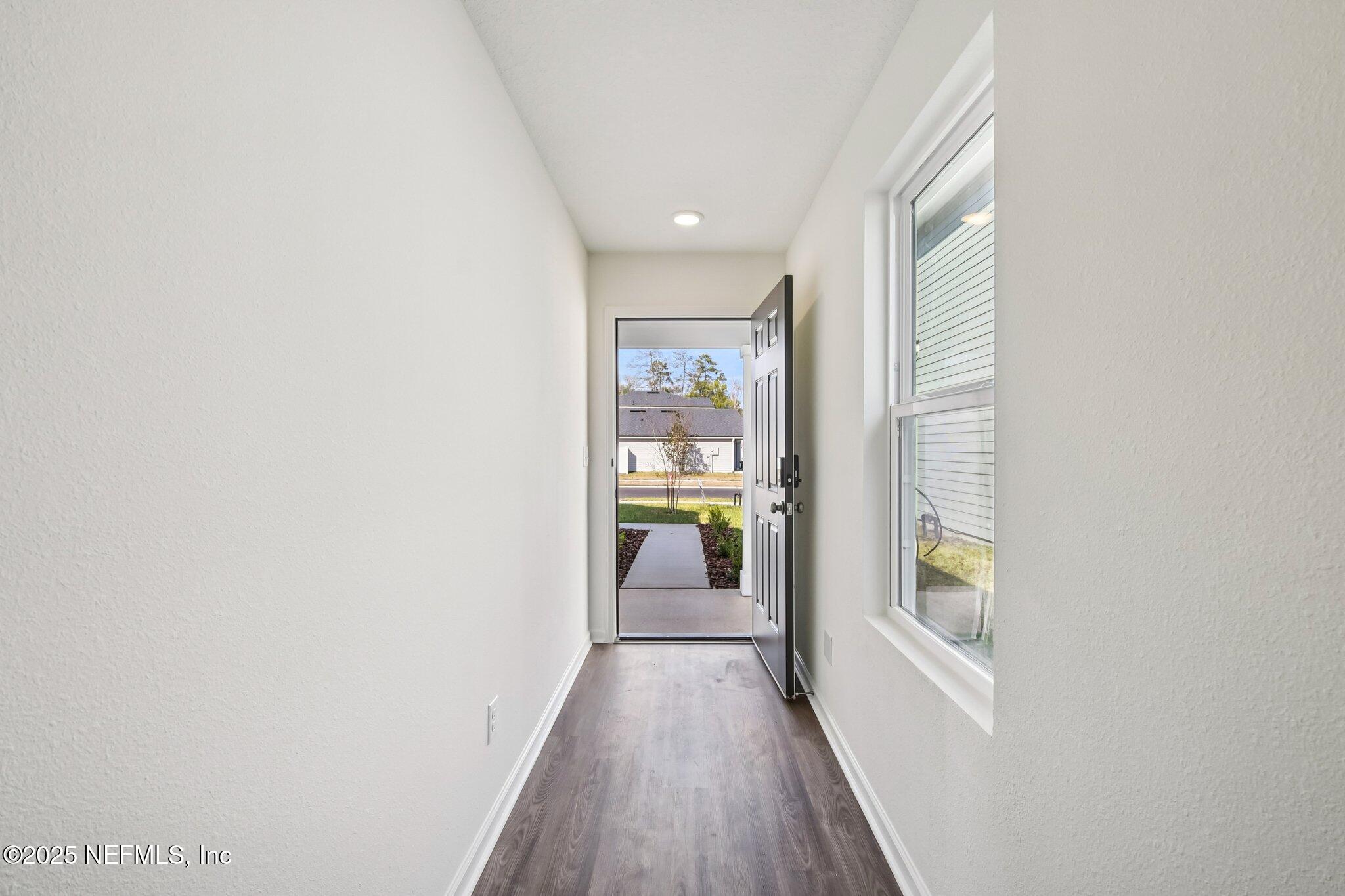 3407 Mildred Way Jacksonville, FL 32254 - Photo 14 of 38 a view of a hallway with wooden floor and a window