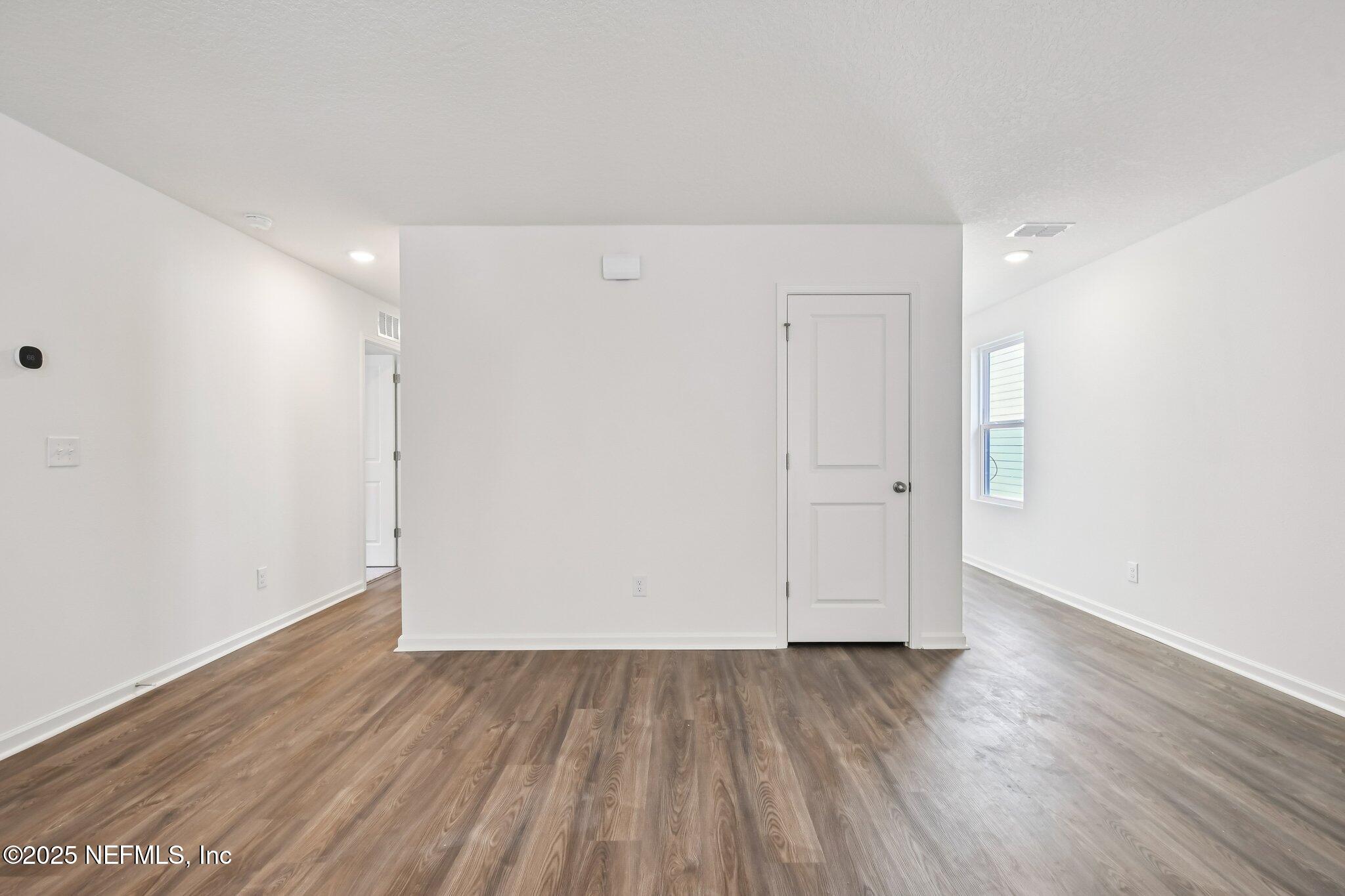 3407 Mildred Way Jacksonville, FL 32254 - Photo 16 of 38 a view of an empty room with wooden floor