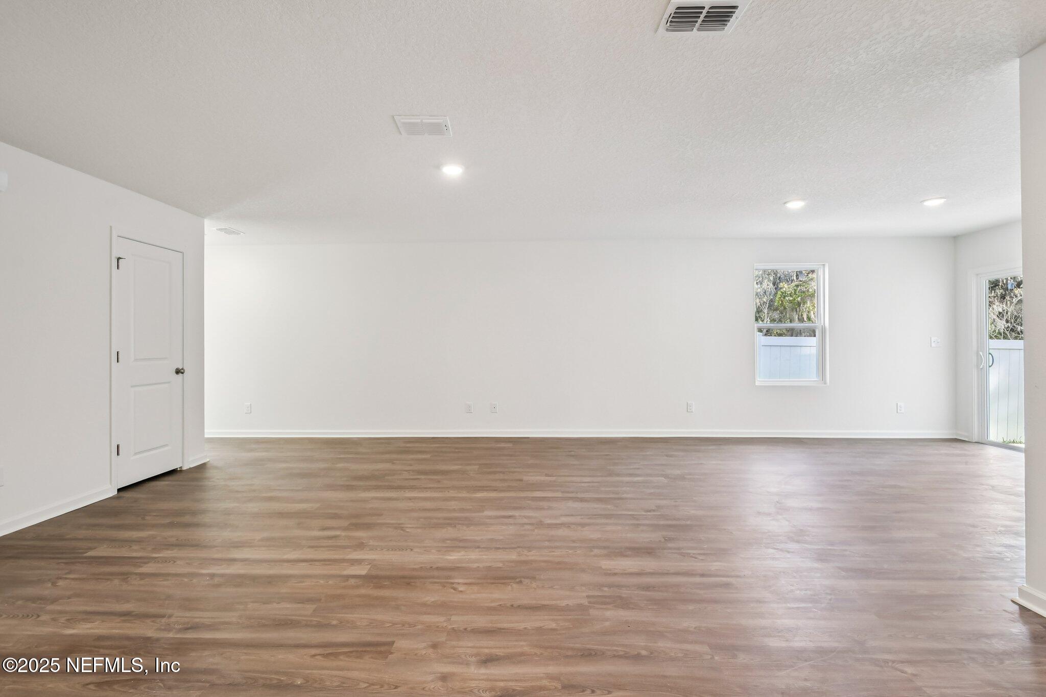 3407 Mildred Way Jacksonville, FL 32254 - Photo 17 of 38 a view of an empty room with wooden floor