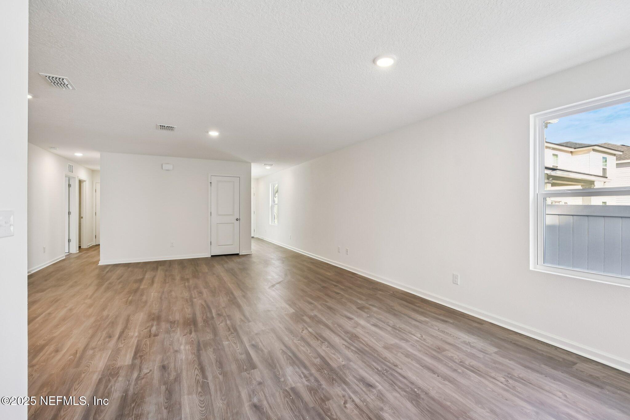 3407 Mildred Way Jacksonville, FL 32254 - Photo 19 of 38 an empty room with wooden floor and windows