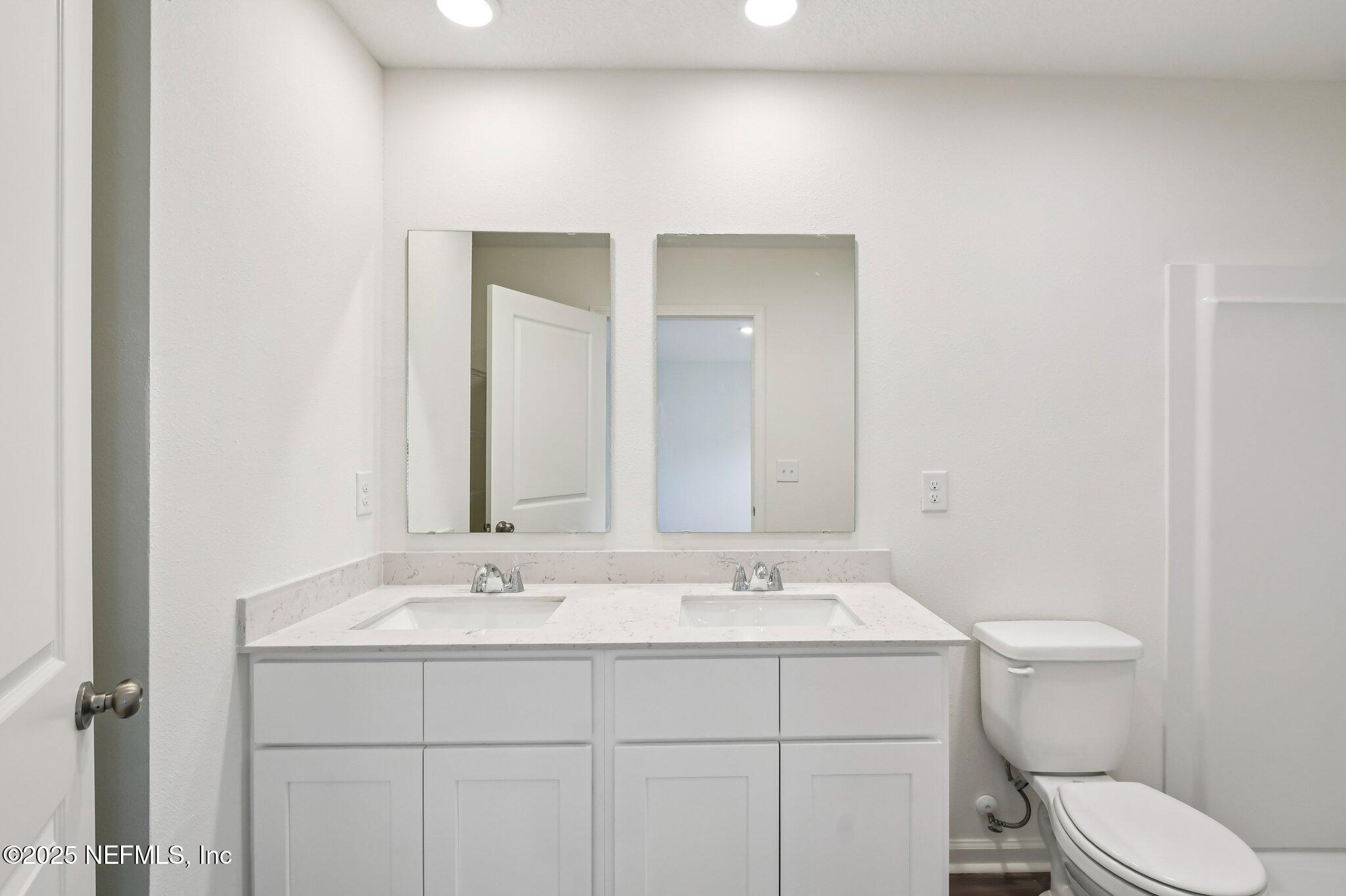 3407 Mildred Way Jacksonville, FL 32254 - Photo 35 of 38 a bathroom with a sink mirror vanity and toilet