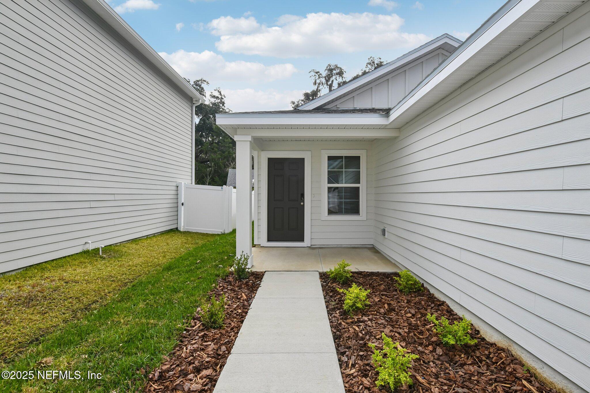 3407 Mildred Way Jacksonville, FL 32254 - Photo 5 of 38 a view of a house with a small yard and a large window