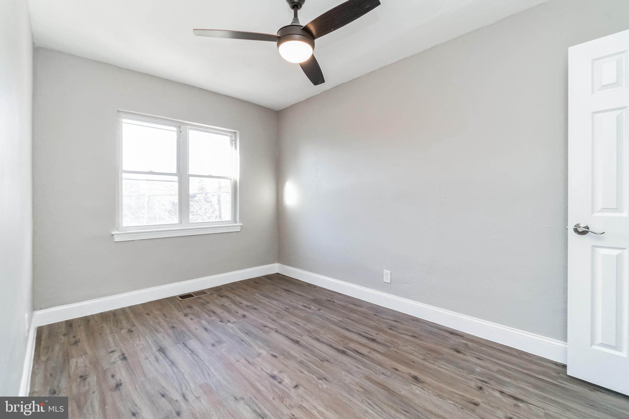 1515 First Street Southwest Washington, DC 20024 - Photo 17 of 37 an empty room with wooden floor ceiling fan and windows