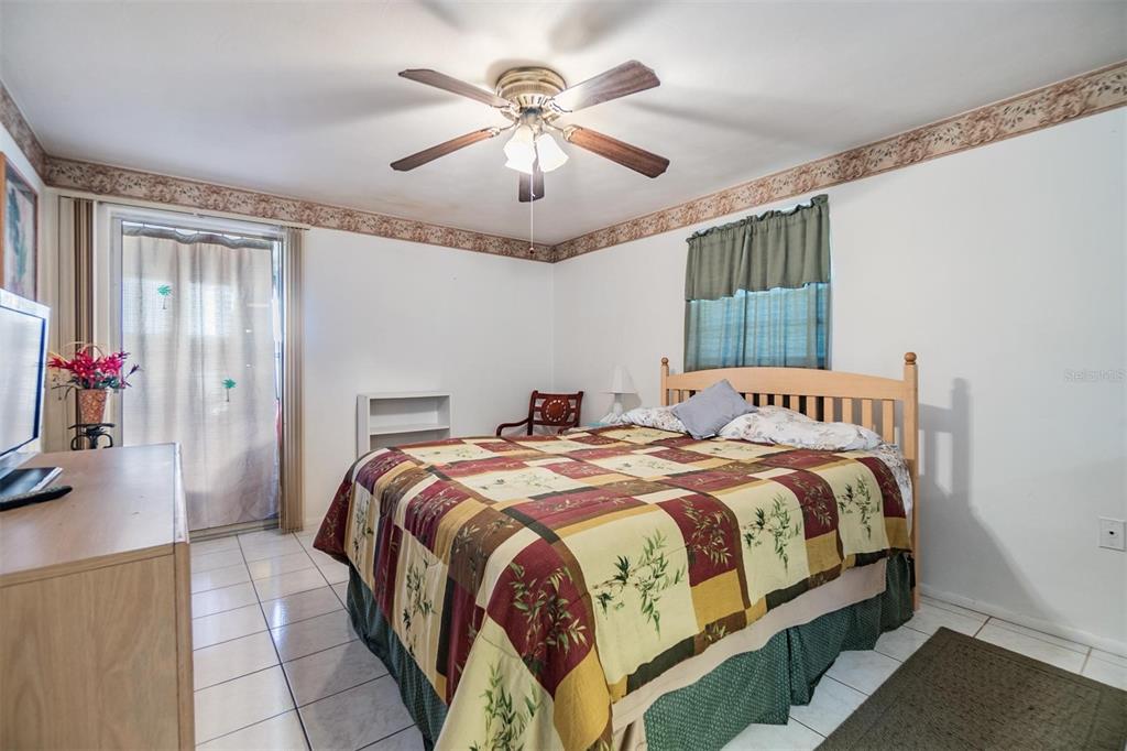 4215 Regal Place, Unit 4215 New Port Richey, FL 34652 - Photo 11 of 16 a bedroom with bed and a chandelier