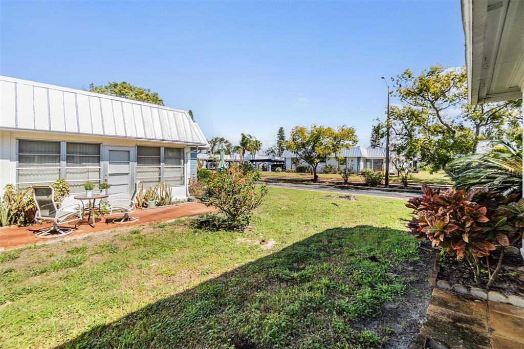 4215 Regal Place, Unit 4215 New Port Richey, FL 34652 - Photo 16 of 16 a view of a house with a yard and sitting area