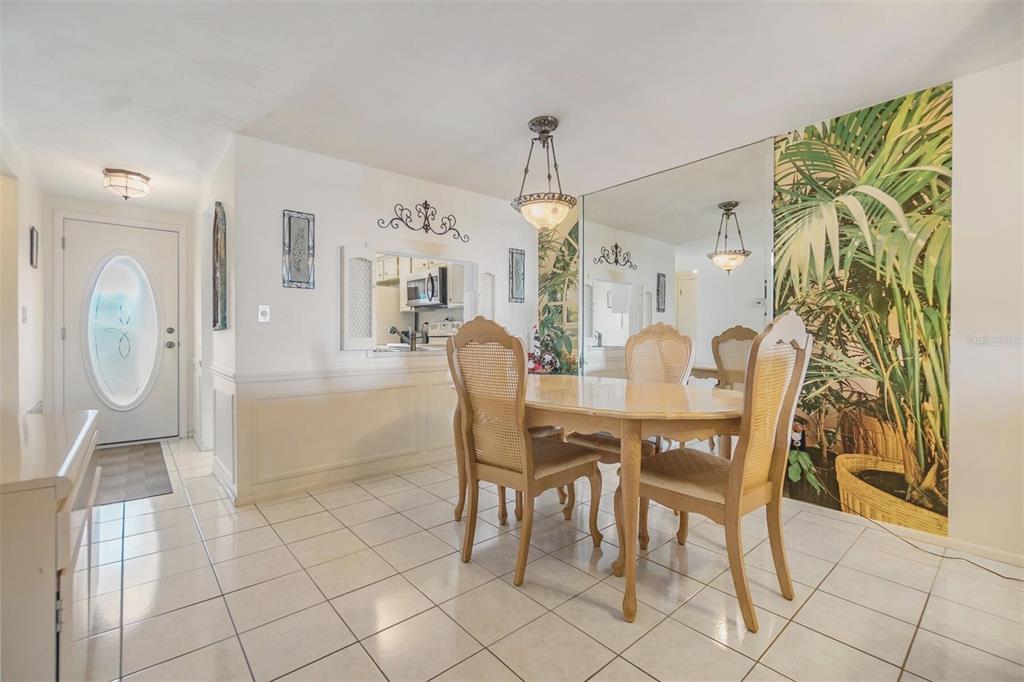 4215 Regal Place, Unit 4215 New Port Richey, FL 34652 - Photo 8 of 16 a dining room with furniture and wooden floor