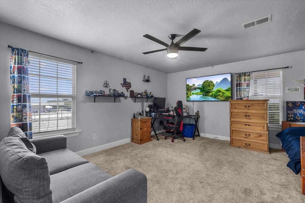 2250 Poolville Cut Off Road Springtown, TX 76082 - Photo 12 of 22 a living room with furniture and windows