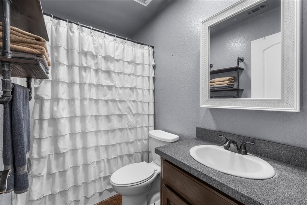 2250 Poolville Cut Off Road Springtown, TX 76082 - Photo 14 of 22 a bathroom with a sink and a toilet
