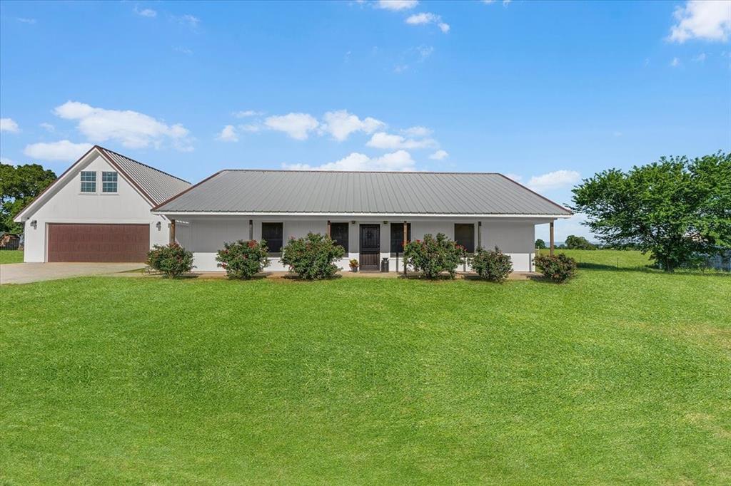 2250 Poolville Cut Off Road Springtown, TX 76082 - Photo 19 of 22 a front view of a house with a yard and trees