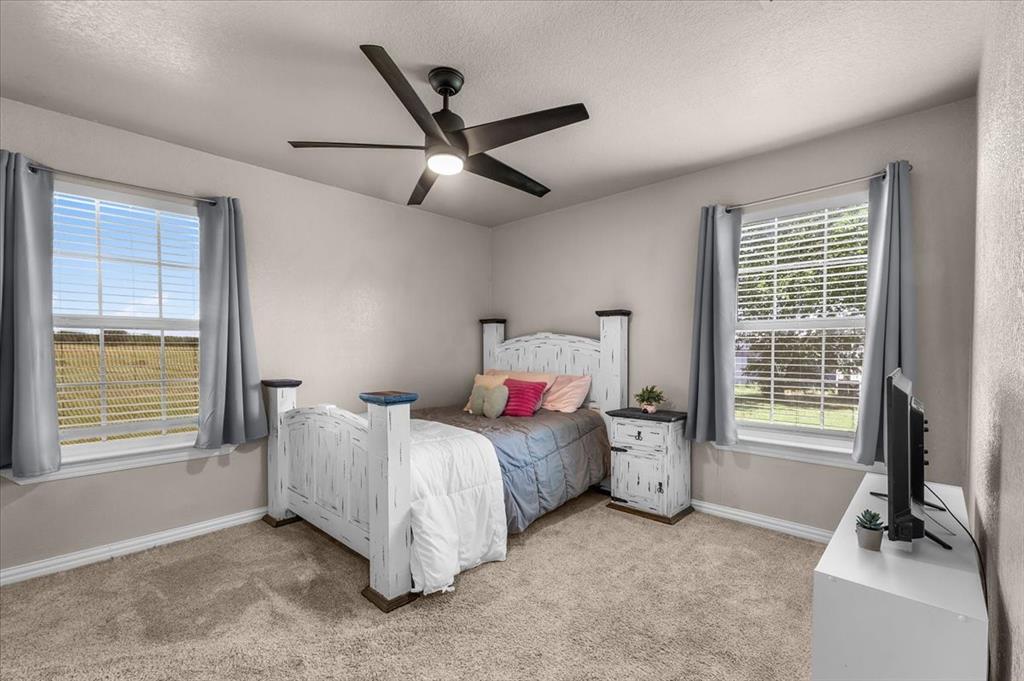 2250 Poolville Cut Off Road Springtown, TX 76082 - Photo 10 of 22 a bedroom with a bed and a window