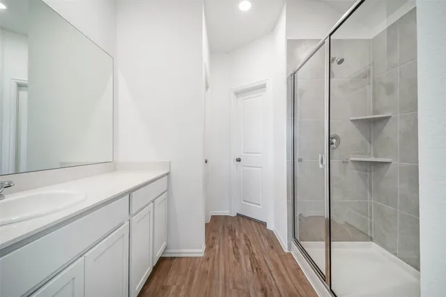 a bathroom with a glass shower door