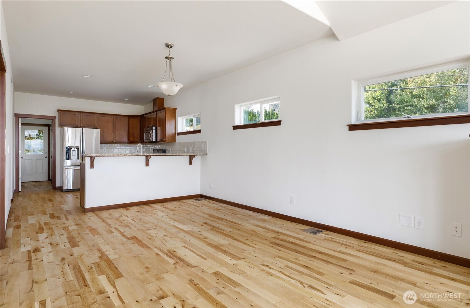 2119 20th Street Anacortes, WA 98221 - Photo 11 of 38 a view of a kitchen with a sink cabinets and wooden floor