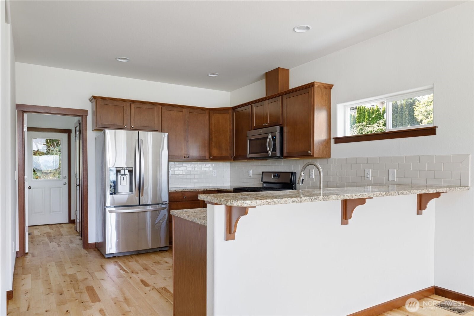 2119 20th Street Anacortes, WA 98221 - Photo 13 of 38 a kitchen with stainless steel appliances granite countertop a refrigerator and a stove