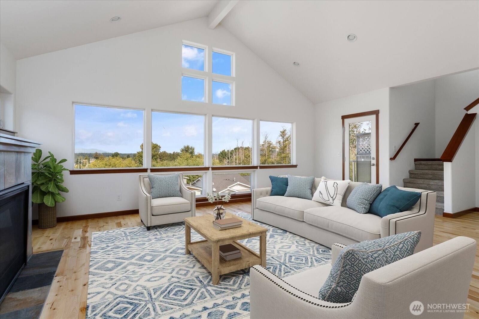2119 20th Street Anacortes, WA 98221 - Photo 7 of 38 a living room with furniture floor to ceiling window and a table