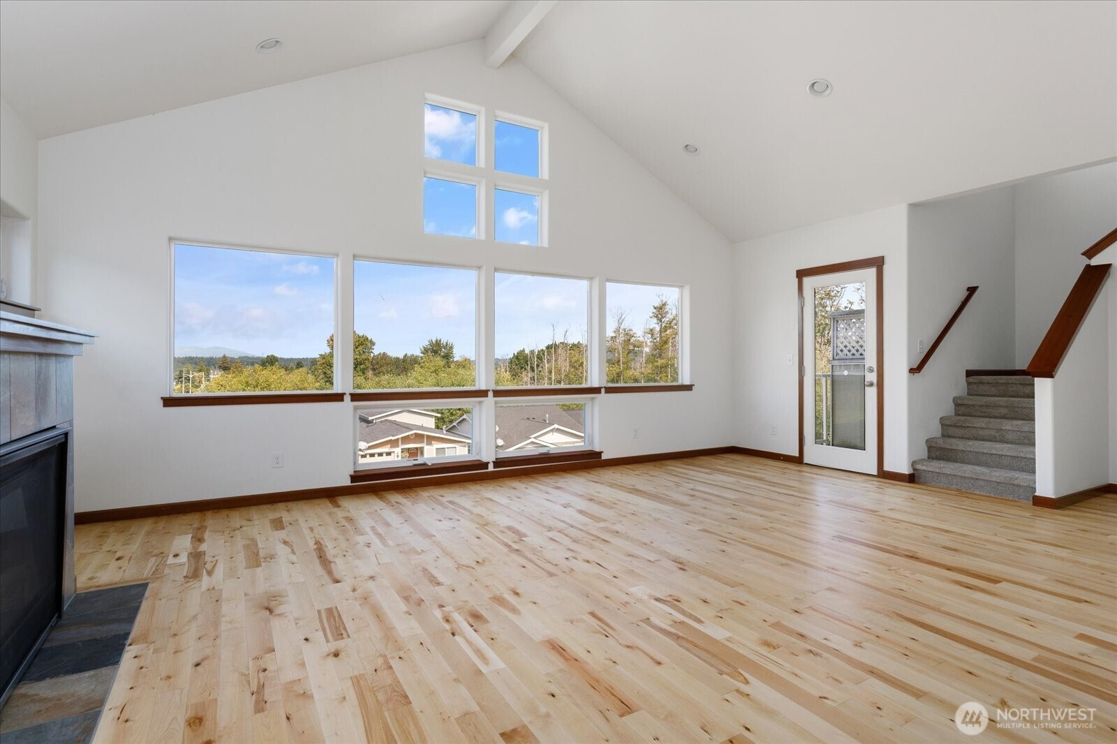 2119 20th Street Anacortes, WA 98221 - Photo 8 of 38 a view of an empty room with wooden floor and a window