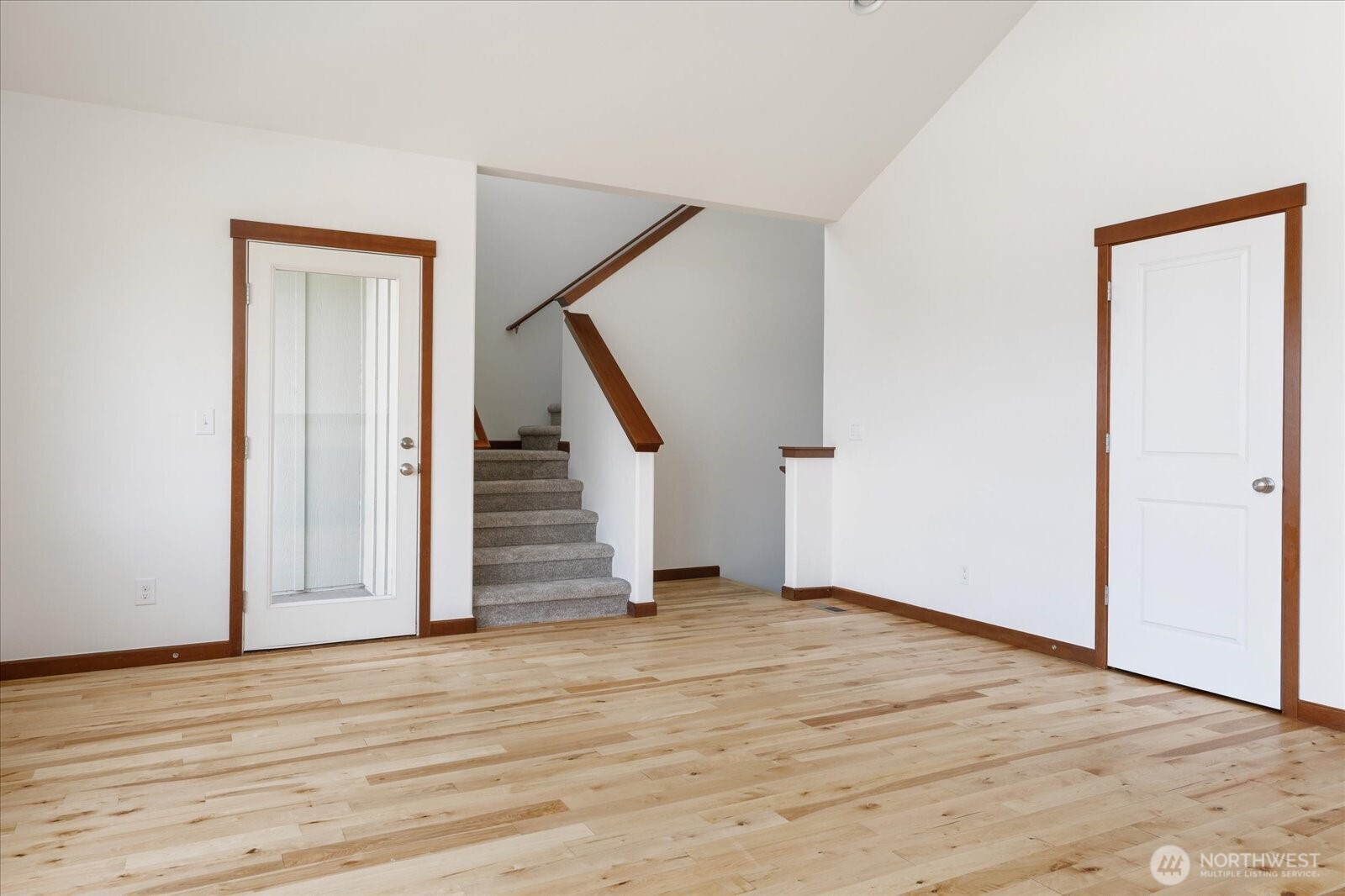2119 20th Street Anacortes, WA 98221 - Photo 9 of 38 a view of an empty room with wooden floor and stairs