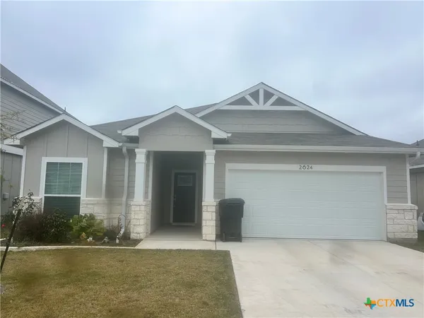 a view of a house with a yard and garage