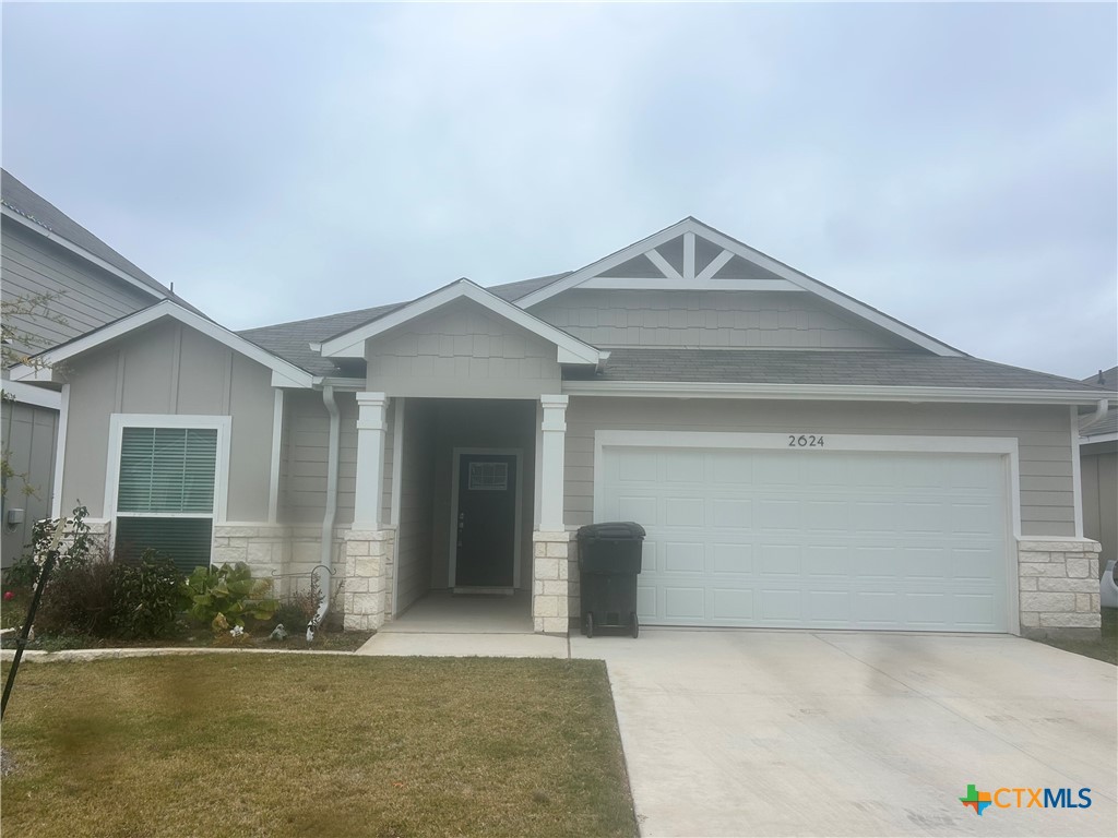 a view of a house with a yard and garage