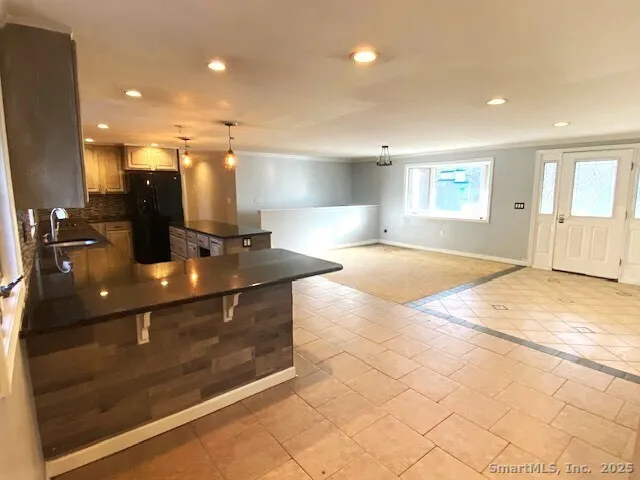 a kitchen with kitchen island a sink stainless steel appliances and cabinets