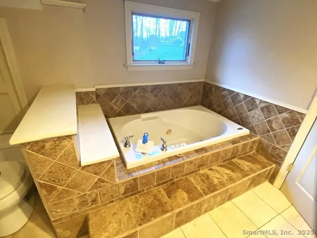 a bath tub sitting in a bathroom next to a window