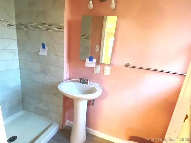 a bathroom with a sink a mirror and shower