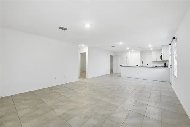 a view of a kitchen with white cabinets and white appliances