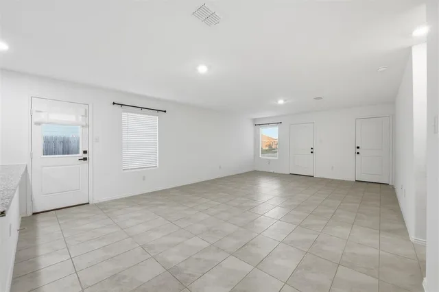 a view of a kitchen with kitchen island and stainless steel appliances