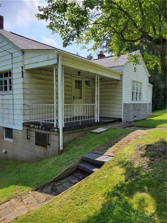 36 Daisytown Road Brownsville, PA 15417 - Photo 2 of 19 a view of a house with a yard and a large tree