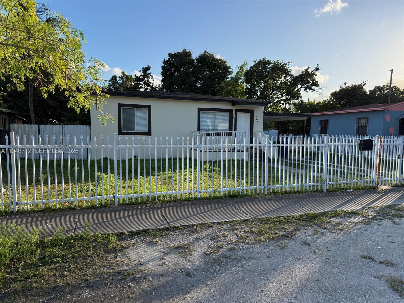 250 Northwest 118th Street Miami, FL 33168 - Photo 1 of 10 a view of a wrought iron fences in front of a yard