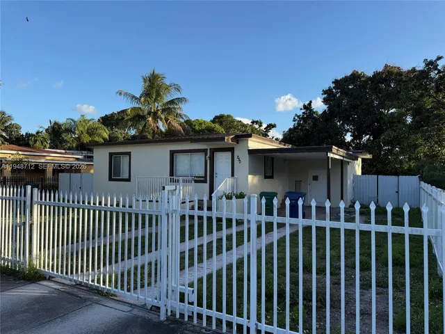 a view of a house with a small yard and plants