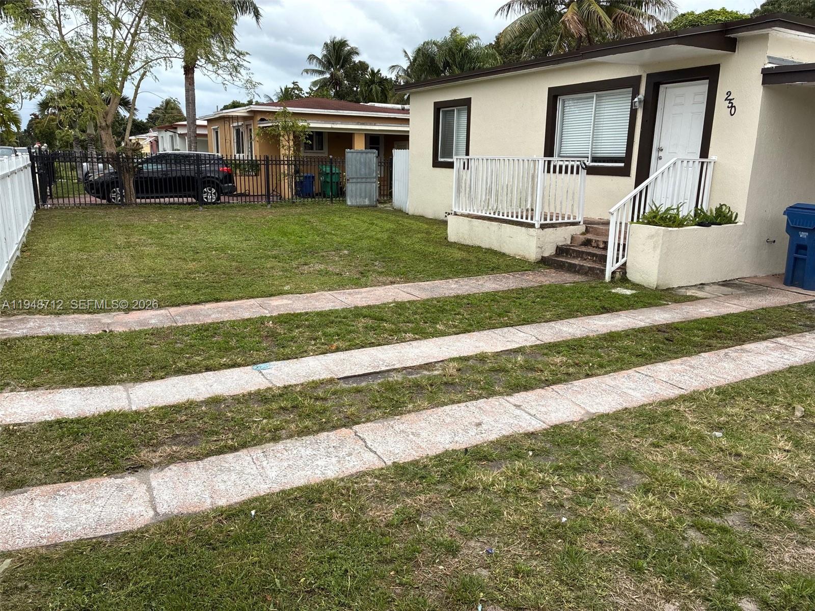 250 Northwest 118th Street Miami, FL 33168 - Photo 3 of 10 a front view of a house with a yard and porch