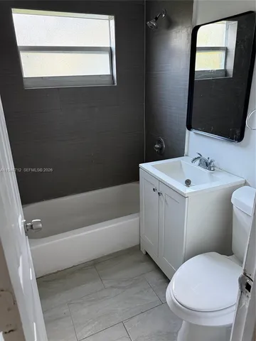 a bathroom with a toilet a sink and bathtub