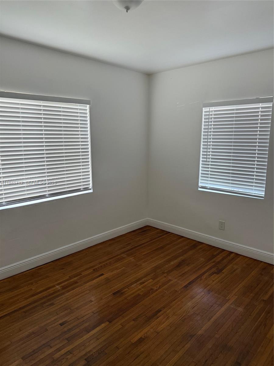 250 Northwest 118th Street Miami, FL 33168 - Photo 10 of 10 a view of an empty room with wooden floor and a window