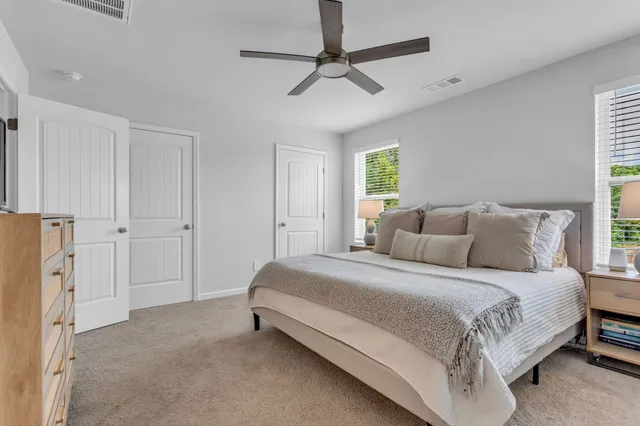 a bedroom with a bed and a ceiling fan