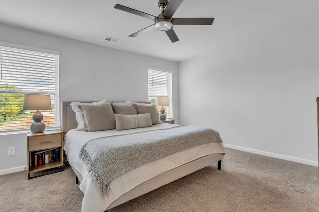 a bedroom with a bed and a ceiling fan