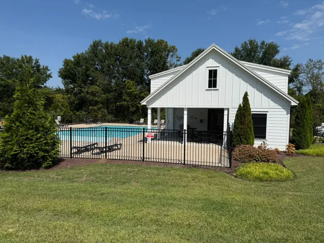 a front view of house with garden and trees