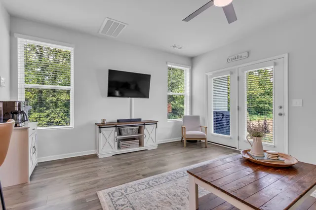 a living room with furniture and a flat screen tv