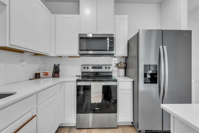 a kitchen with a refrigerator stove and microwave