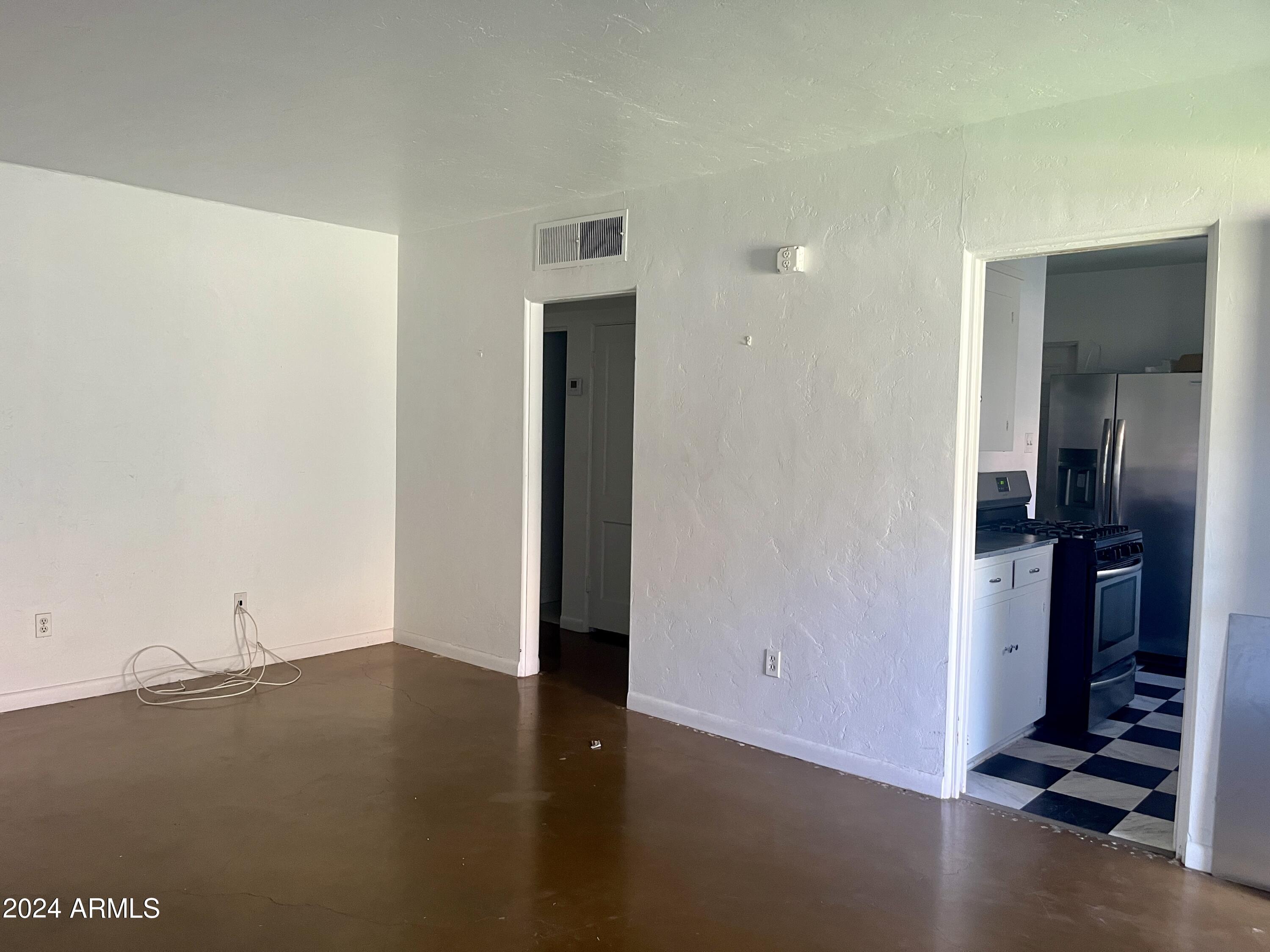 15 East Oregon Avenue, Unit 15 Phoenix, AZ 85012 - Photo 12 of 14 a view of an empty room and kitchen
