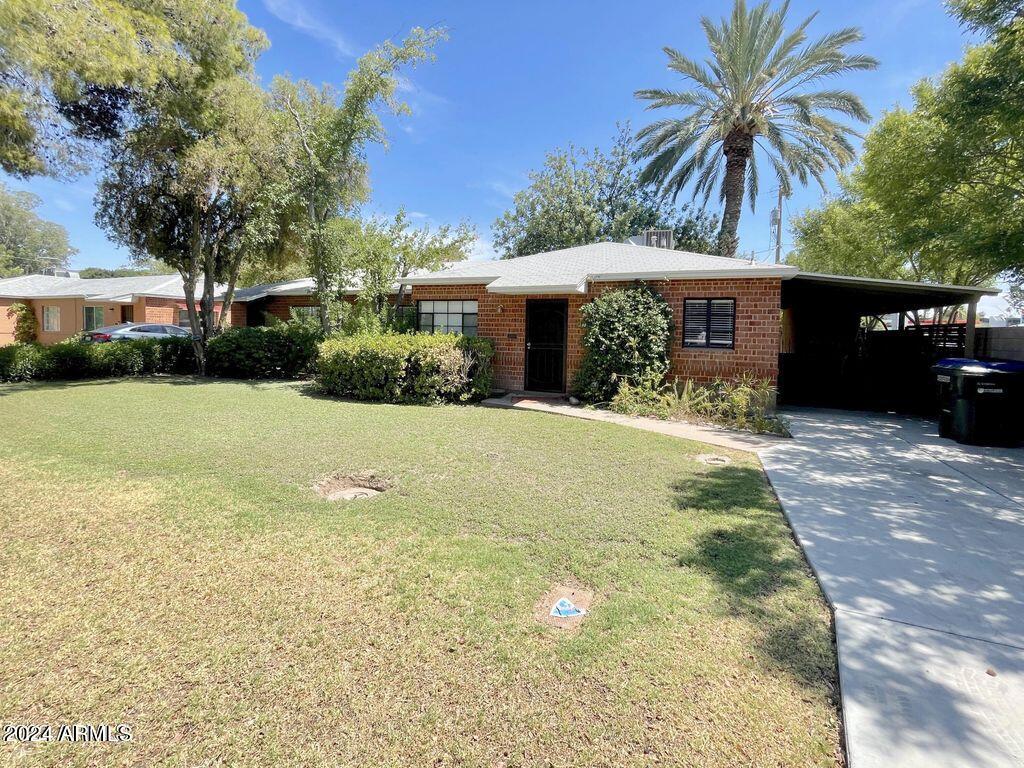 15 East Oregon Avenue, Unit 15 Phoenix, AZ 85012 - Photo 2 of 14 a front view of a house with yard and green space