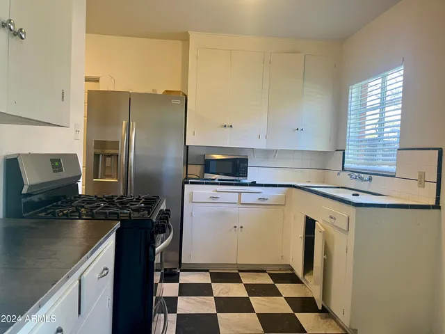 a kitchen with a refrigerator sink and microwave