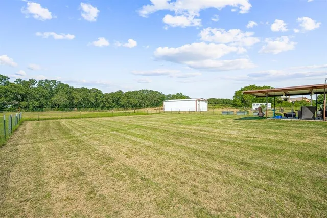 a view of a lake with houses in the background