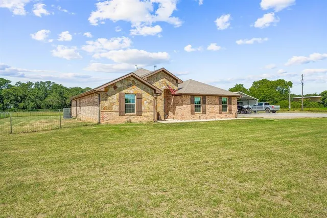 a view of a house with a big yard