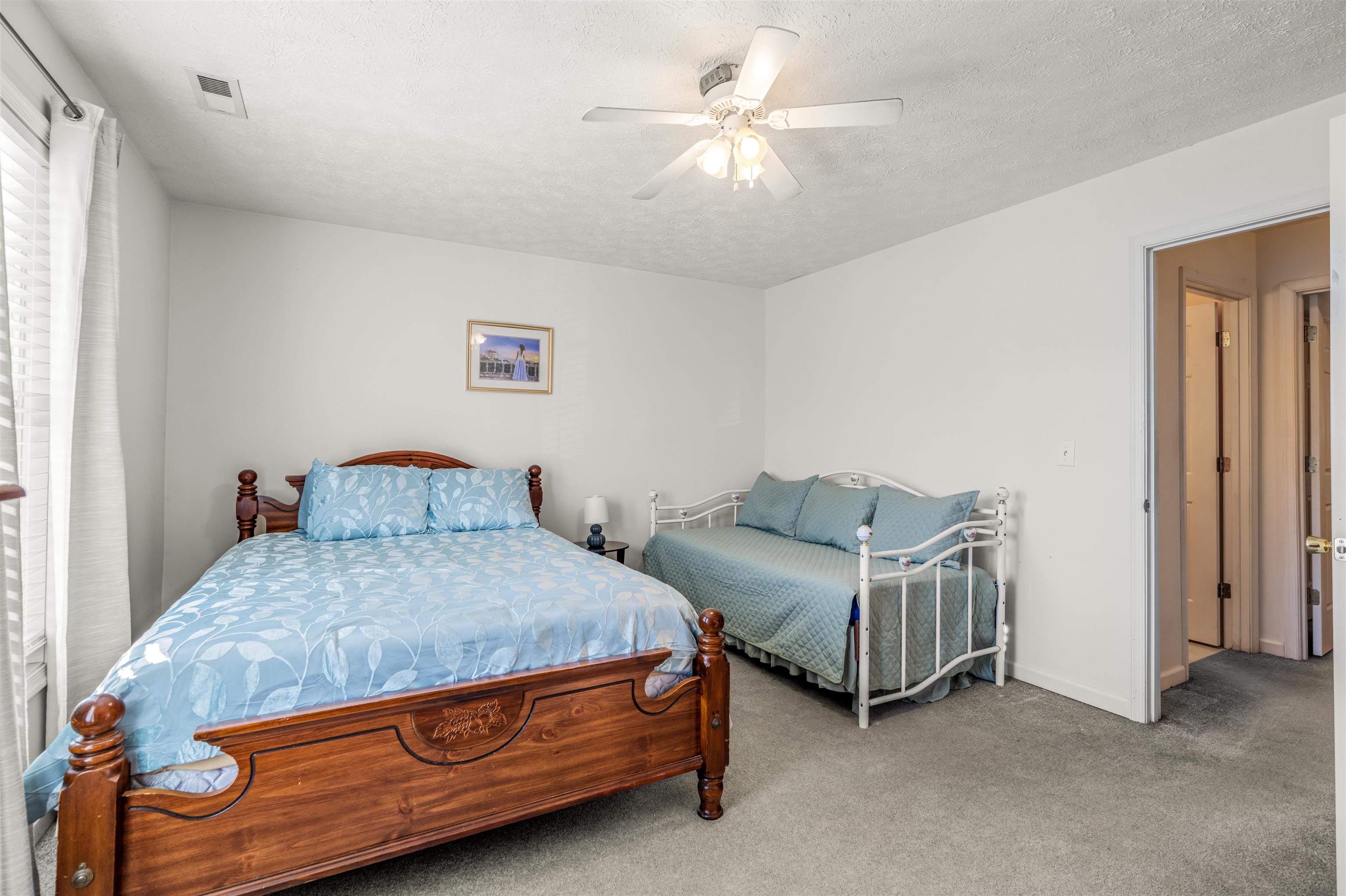 1046 Bridge Avenue Waynesboro, VA 22980 - Photo 18 of 23 a bedroom with a bed and a chandelier