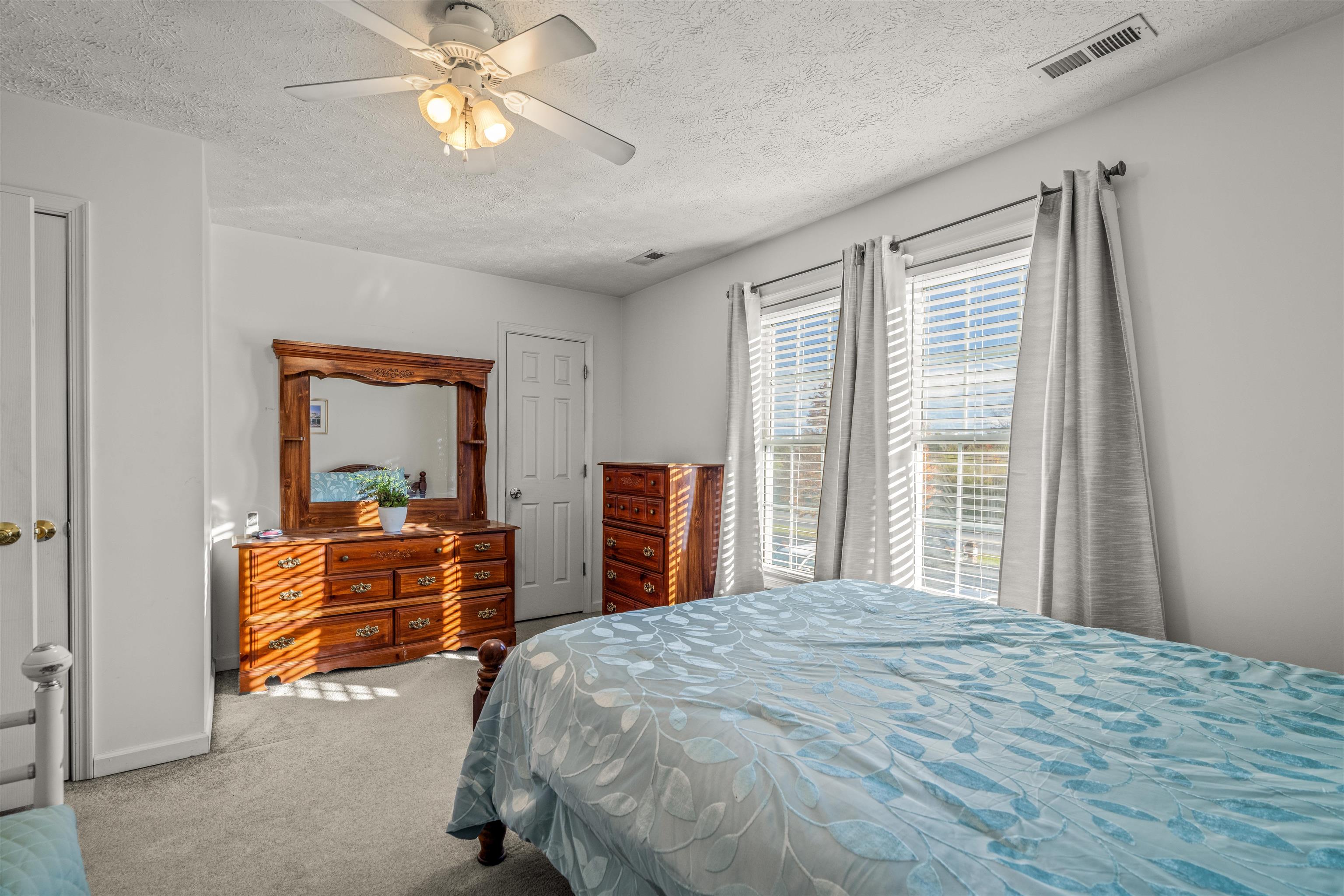1046 Bridge Avenue Waynesboro, VA 22980 - Photo 20 of 23 a bedroom with a bed and a chandelier