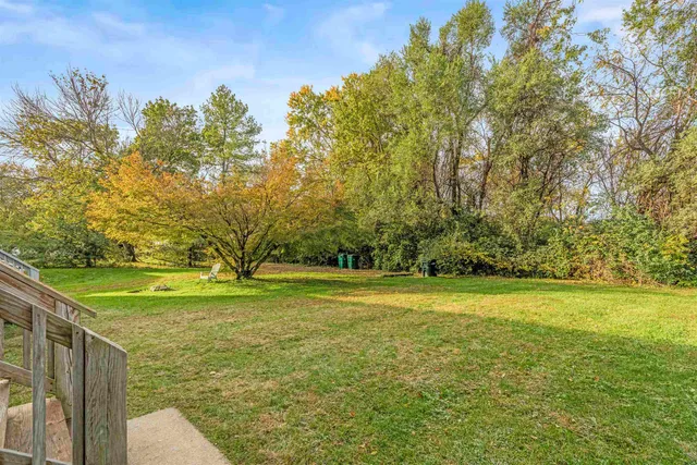 a view of a big yard with wooden fence
