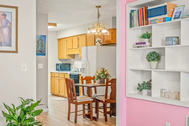a dining room with furniture a rug and wooden floor