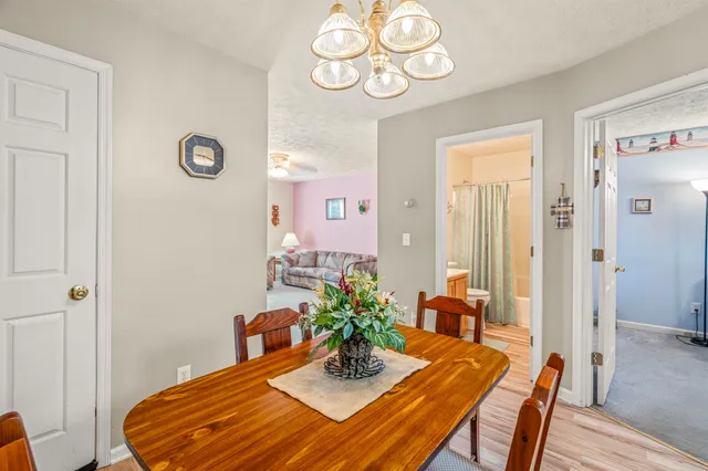 a dining room with furniture and wooden floor