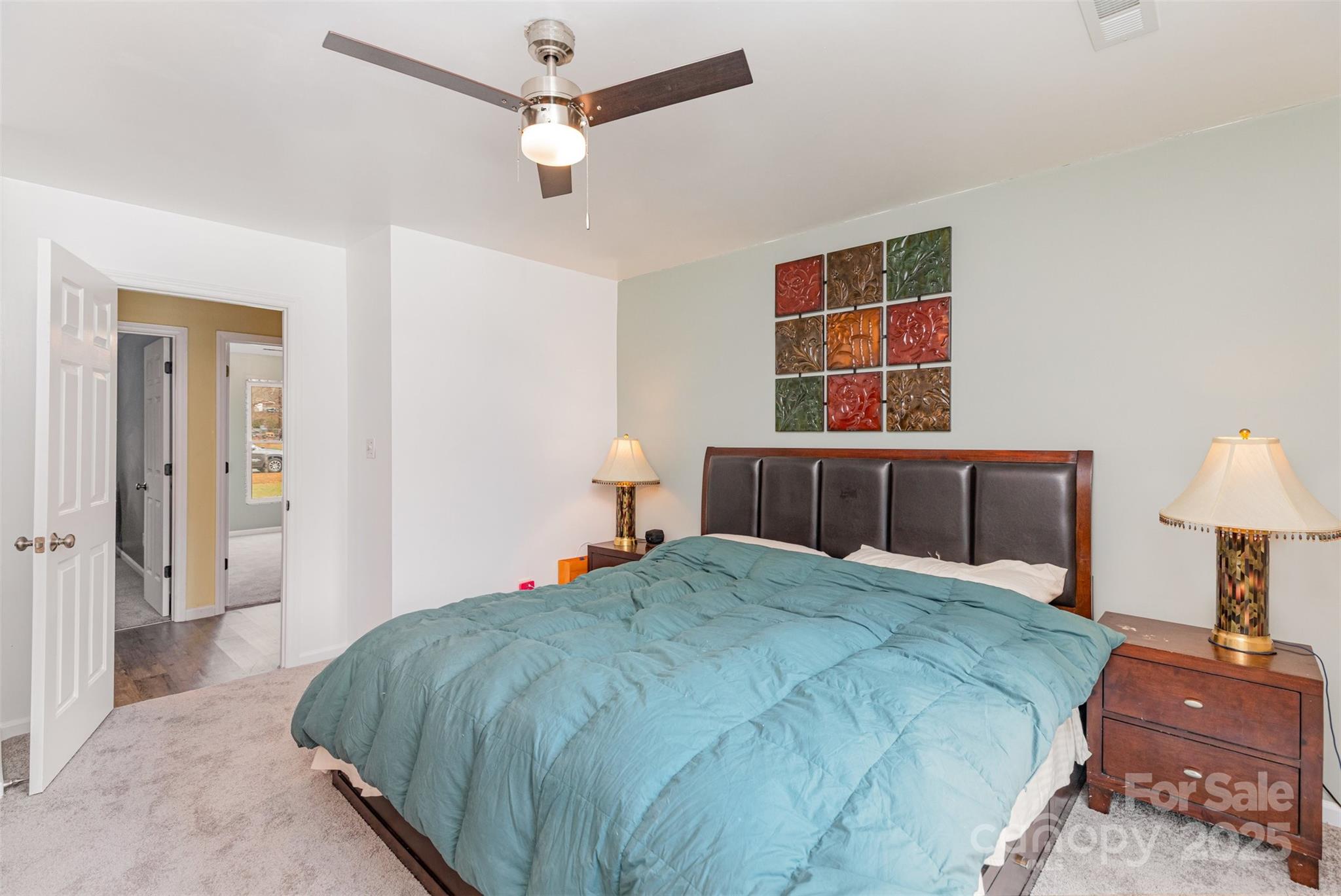 2241 Indian Cross Trail Matthews, NC 28104 - Photo 12 of 46 a bedroom with a bed and a lamp on table