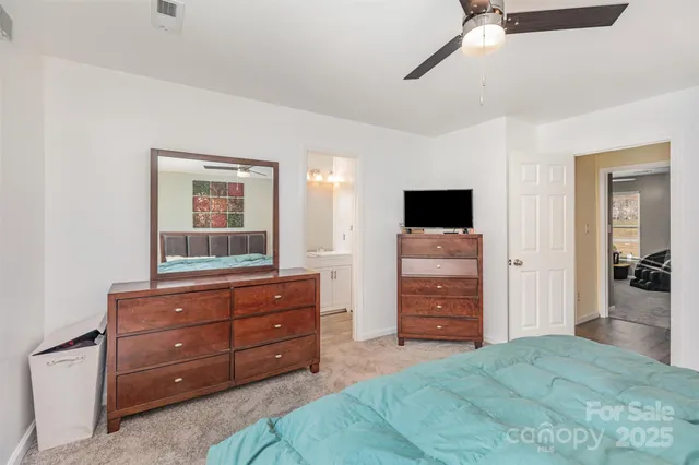 a room with a bed and a television